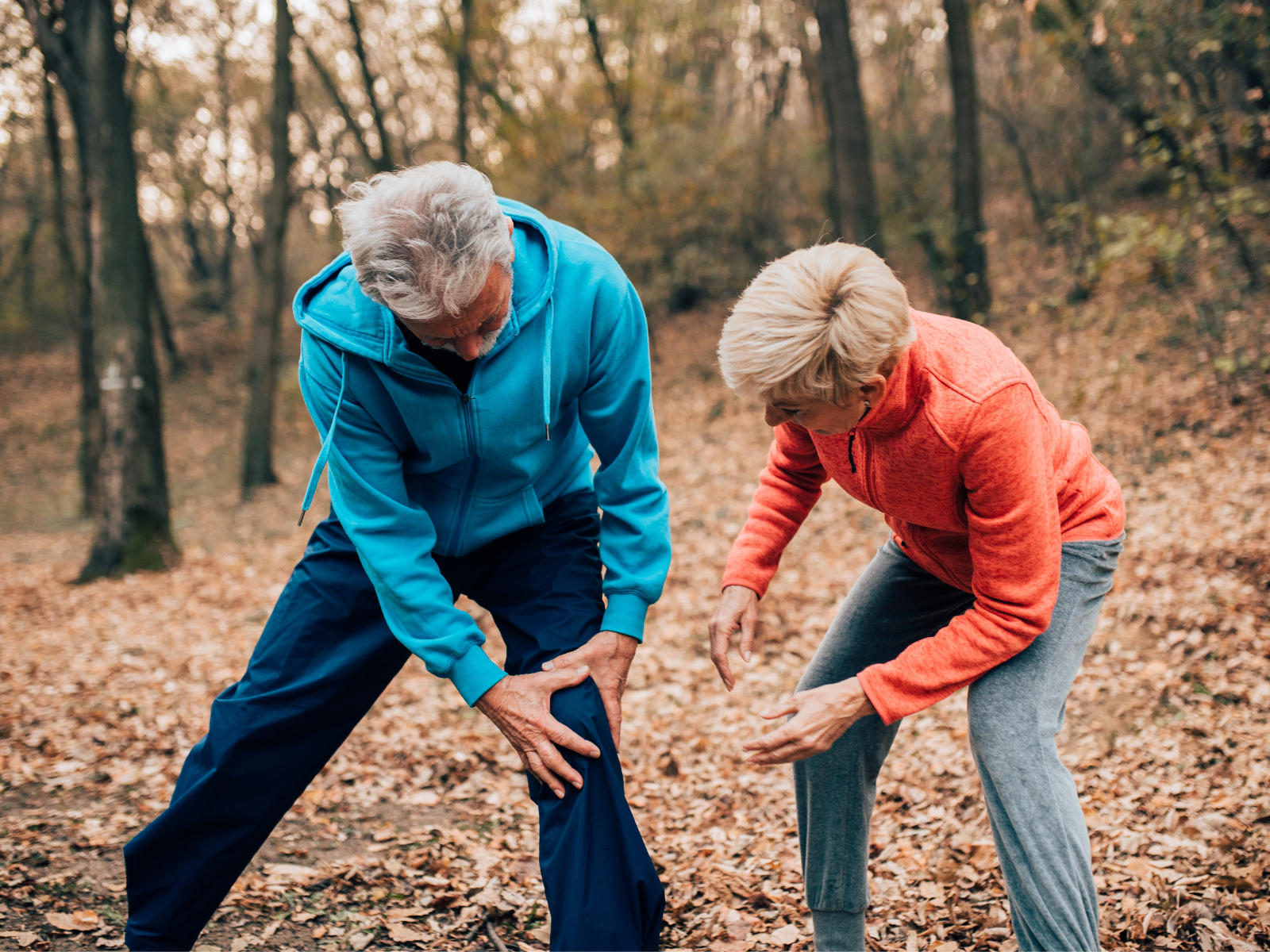 Senior couple exercising man with knee pain